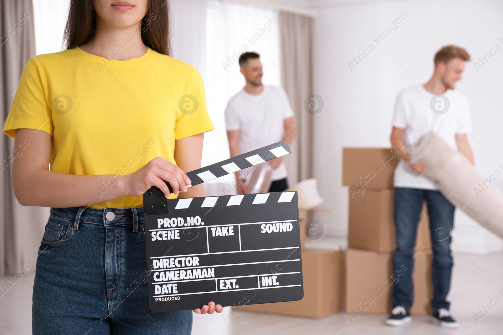 Photo of Operator holding clapperboard during the production indoors, closeup