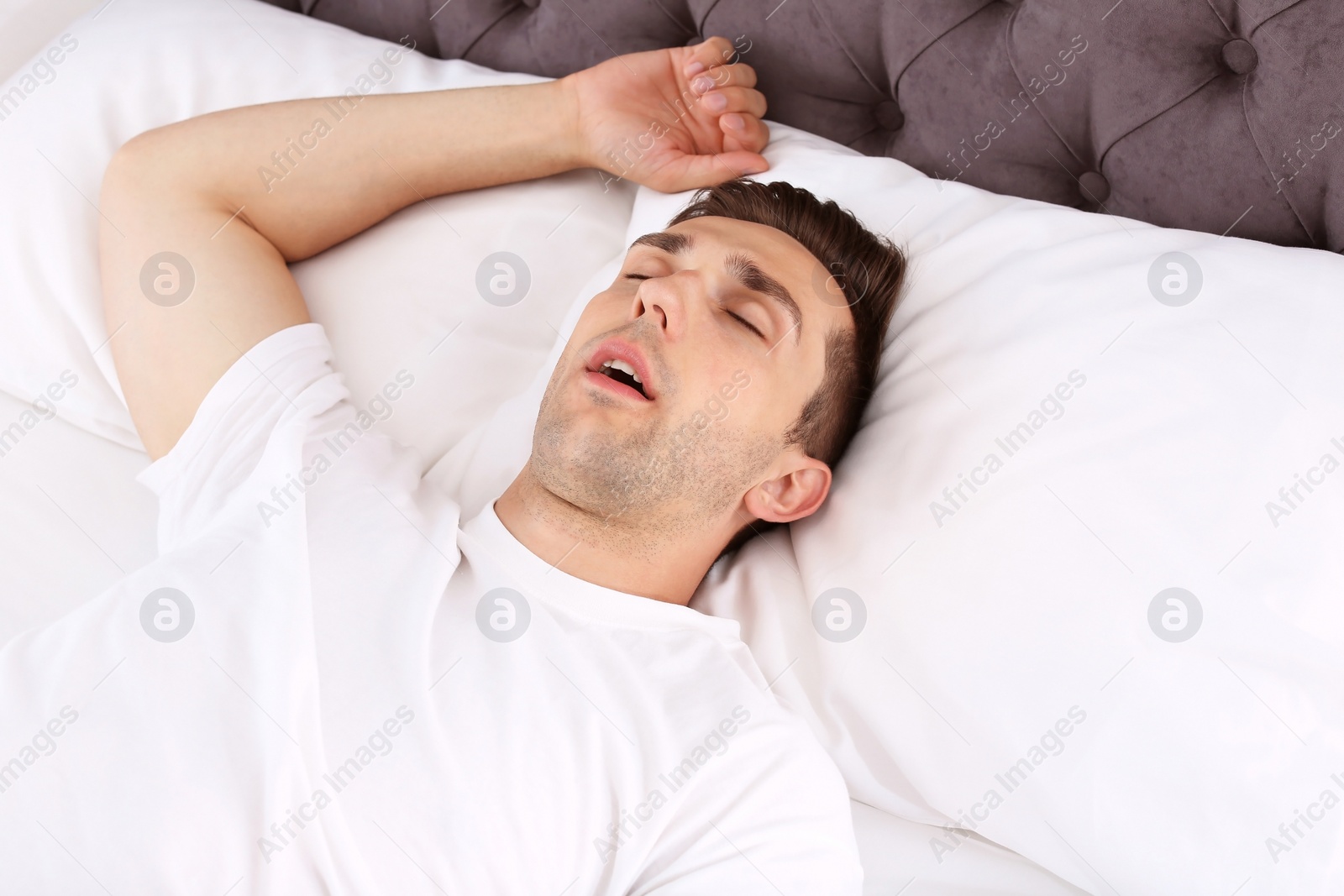 Photo of Young man sleeping in bed at home