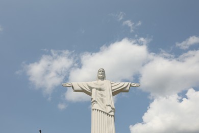 Photo of Truskavets, Ukraine - July 14, 2023: Beautiful statue of Jesus Christ against blue sky, low angle view