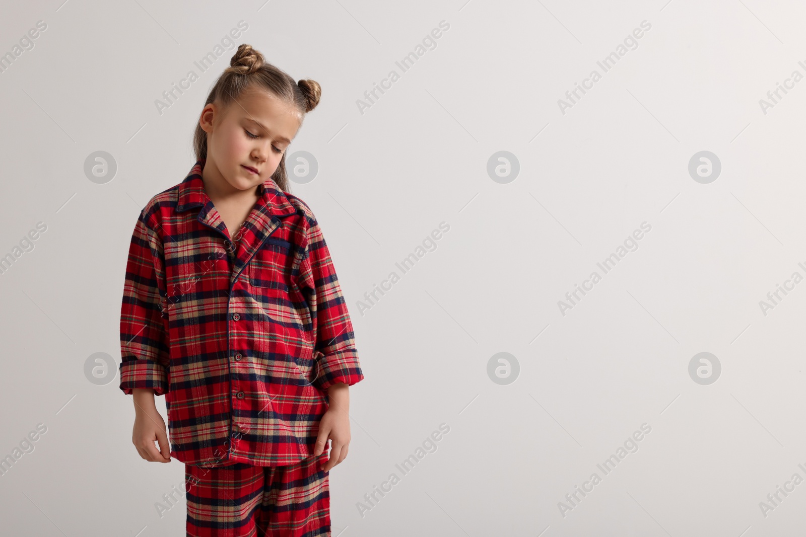 Photo of Girl in pajamas sleepwalking on white background, space for text