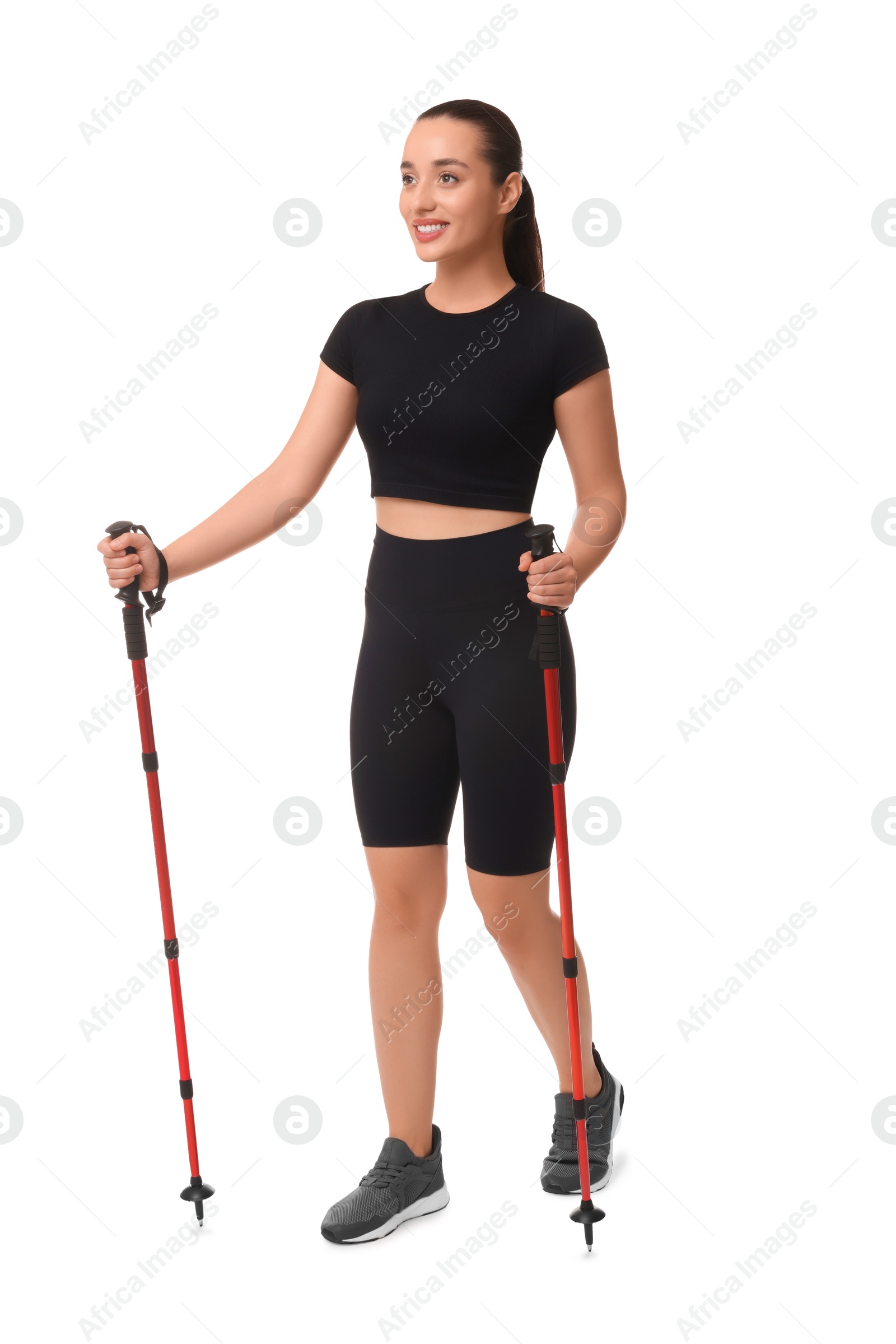 Photo of Young woman practicing Nordic walking with poles isolated on white