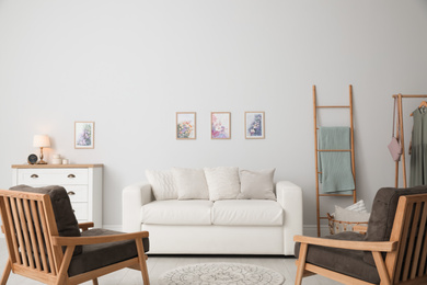 Photo of Modern living room interior with comfortable sofa and armchairs