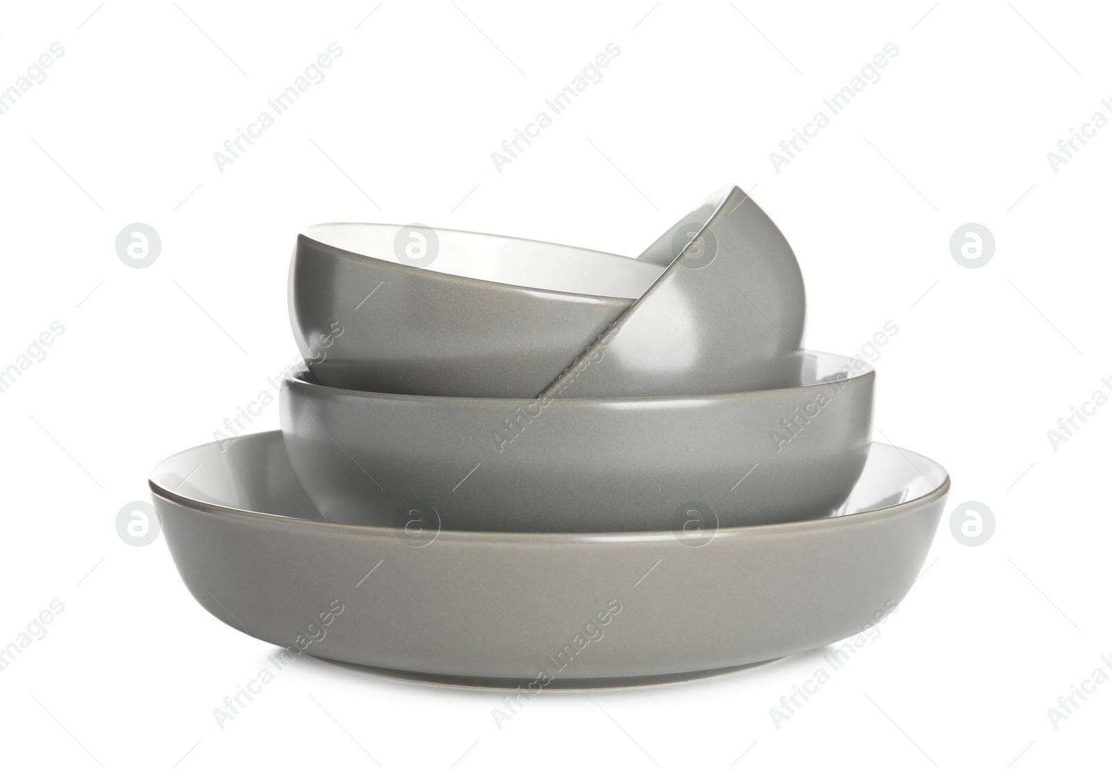 Photo of Stack of clean ceramic dishware isolated on white