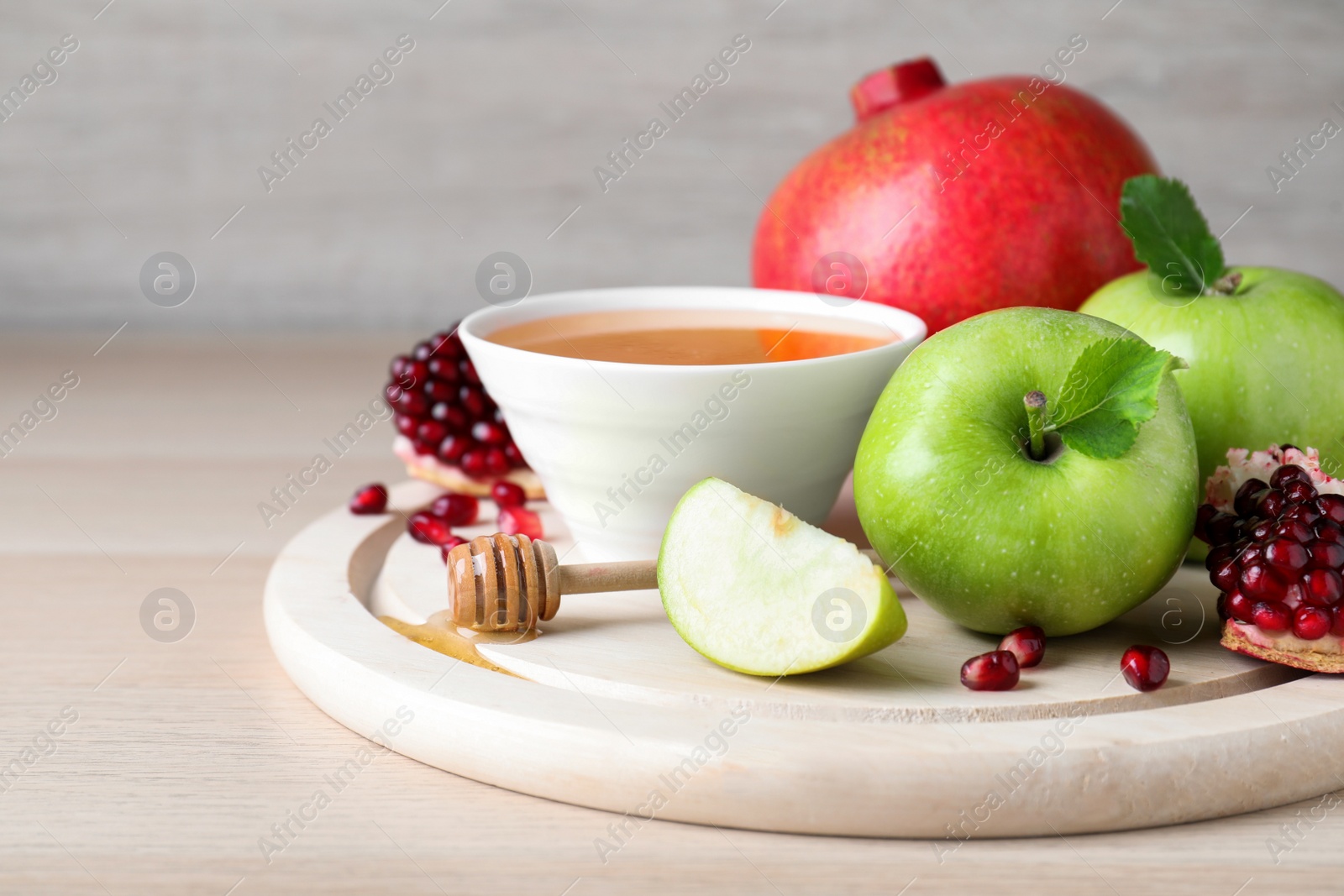 Photo of Honey, pomegranate and apples on wooden table. Rosh Hashana holiday