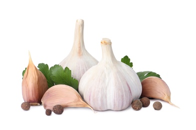 Photo of Fresh garlic bulbs and cloves with seasonings on white background. Organic food
