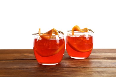 Aperol spritz cocktail and orange slices in glasses on wooden table against white background