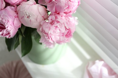 Photo of Bouquet of beautiful peonies on window sill, closeup. Space for text