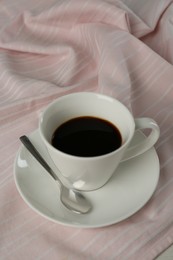 Photo of Cup of aromatic coffee on white wooden table