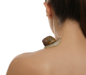 Photo of Beautiful young woman with snail on her back against white background, closeup