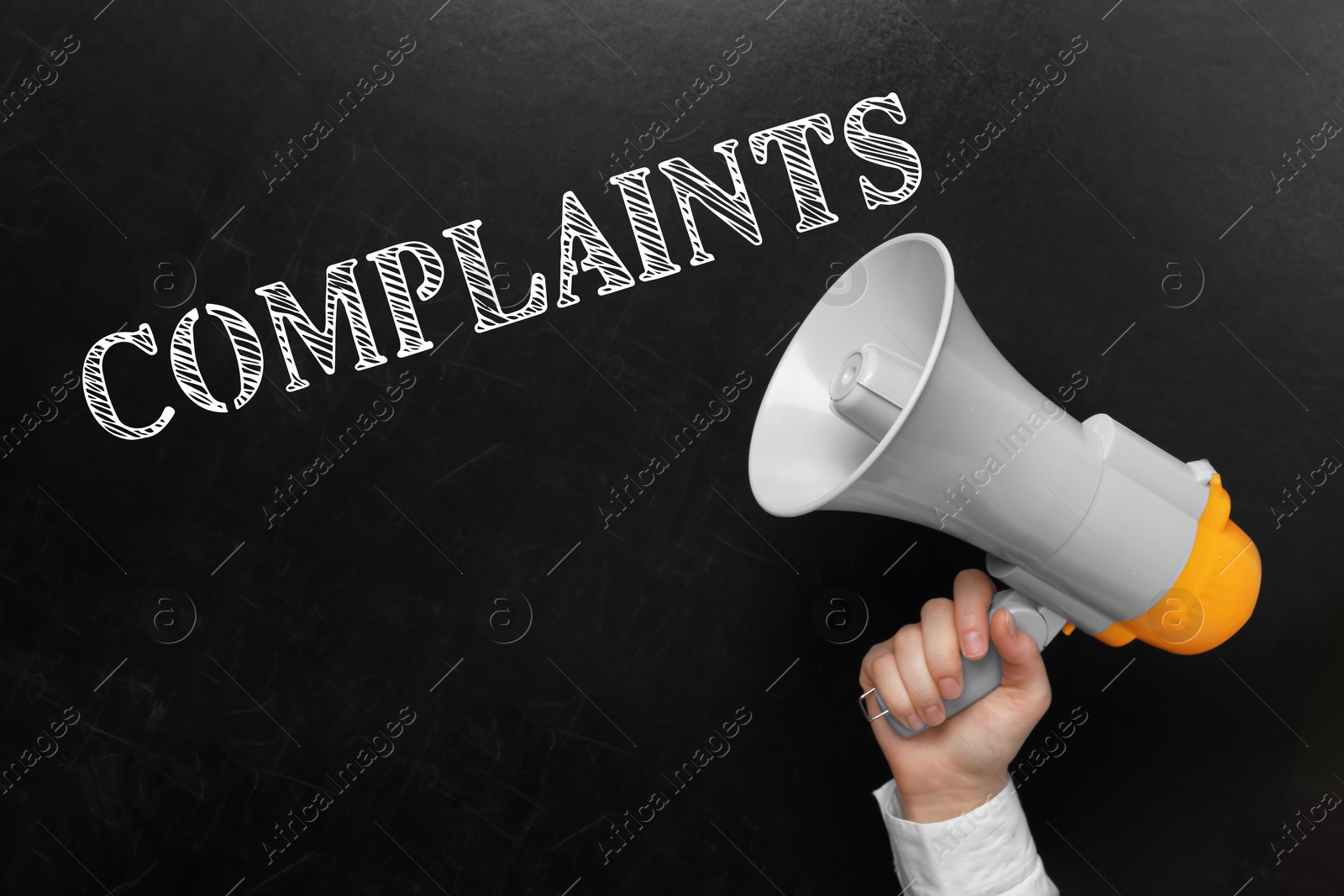 Image of Man holding megaphone near blackboard with word Complaints, closeup