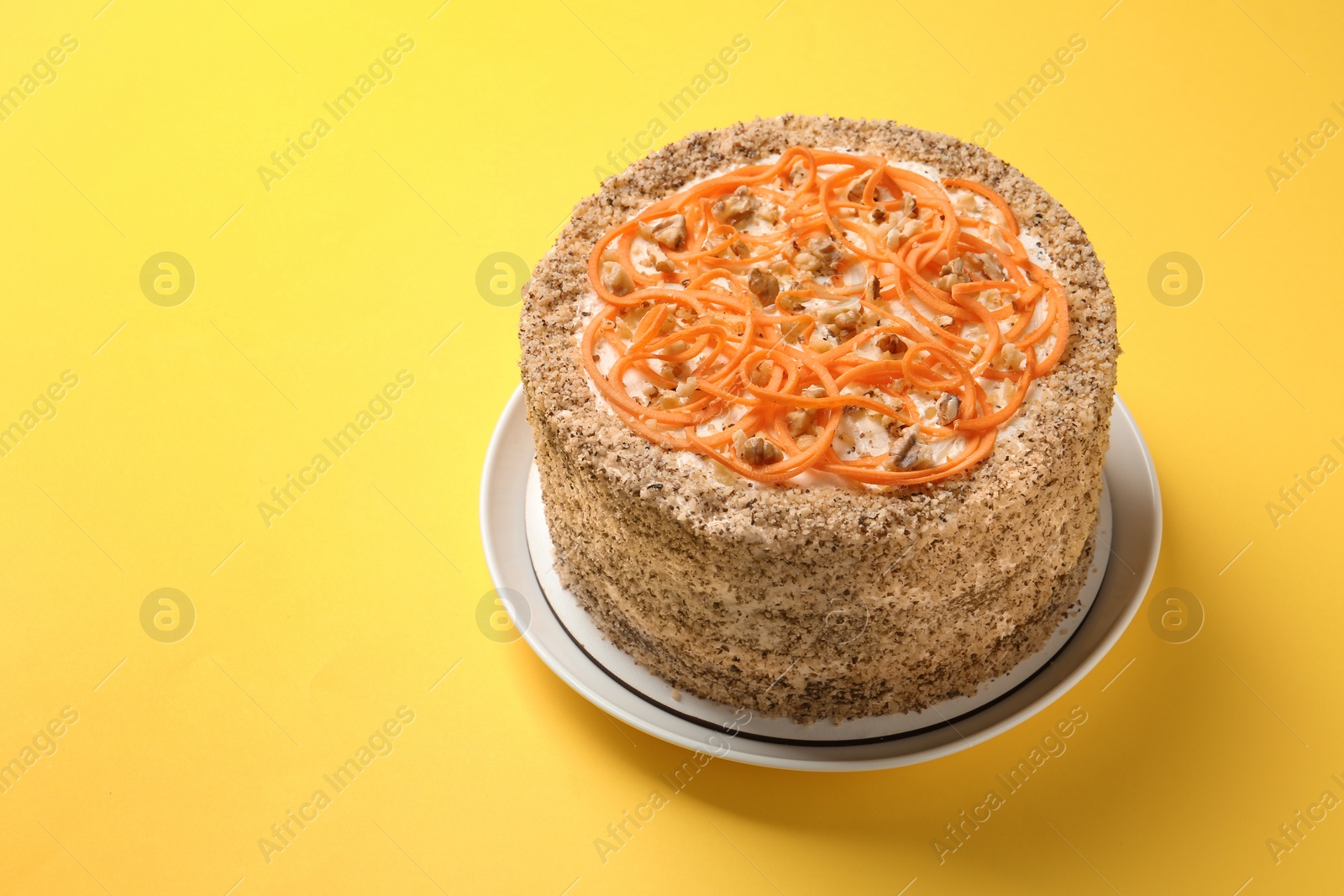 Photo of Dish with delicious carrot cake on color background. Space for text