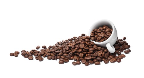Photo of Overturned cup with roasted coffee beans on white background
