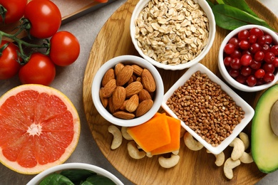 Photo of Assortment of heart-healthy products on grey background, flat lay