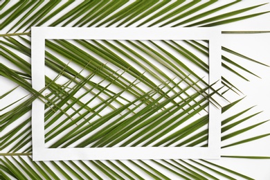 Beautiful composition with tropical leaves on light background, top view