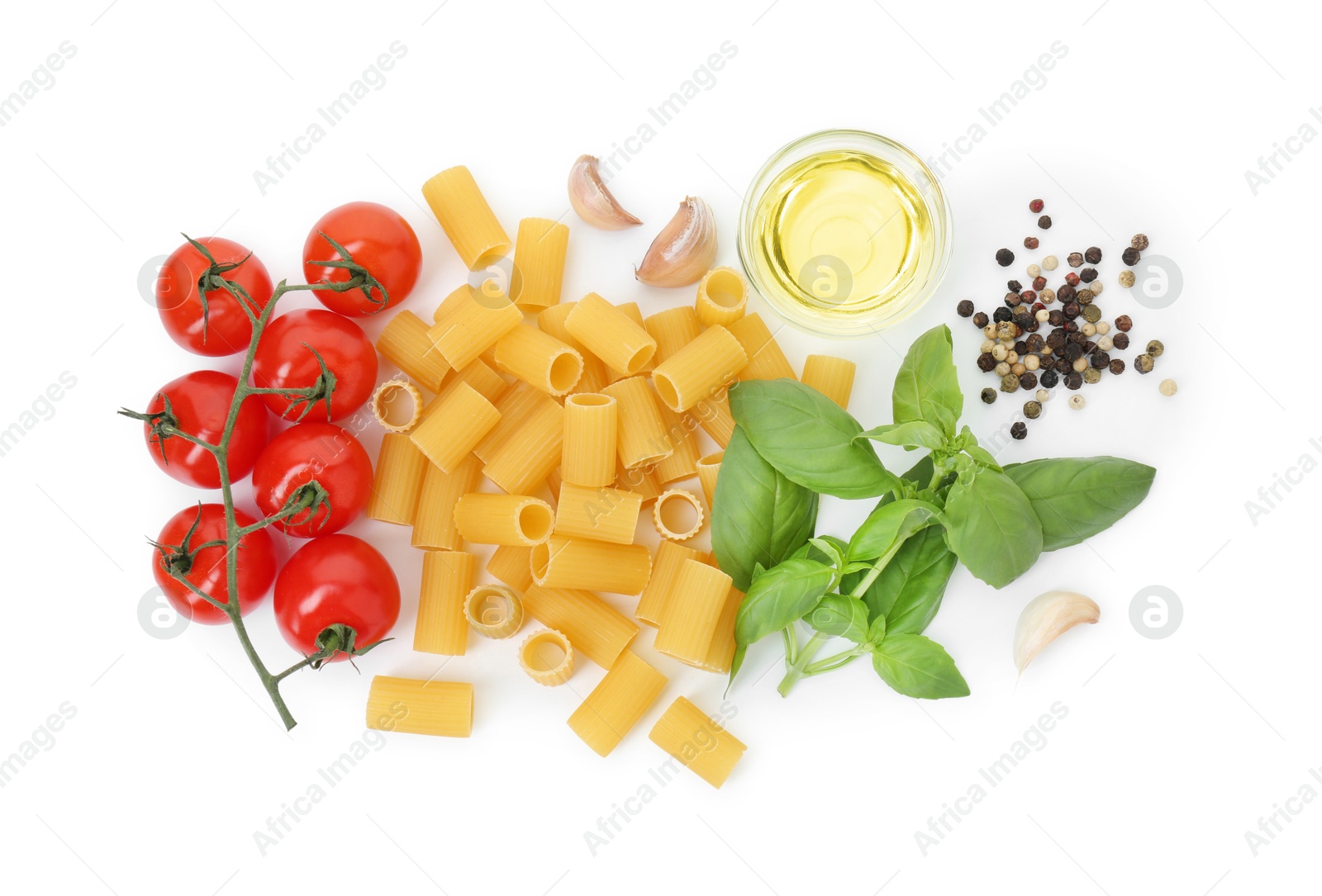 Photo of Uncooked rigatoni pasta and ingredients on white background, top view