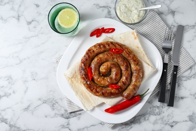 Photo of Tasty homemade sausage with chili pepper and lavash served on white marble table, flat lay