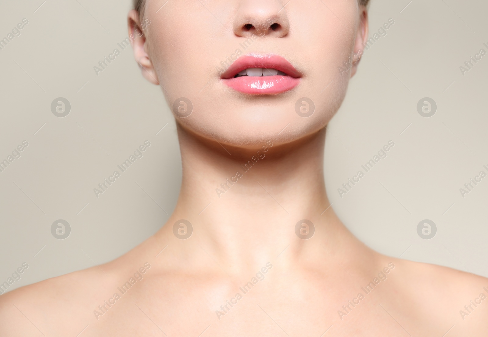 Photo of Beautiful young woman with perfect lips makeup on light background, closeup