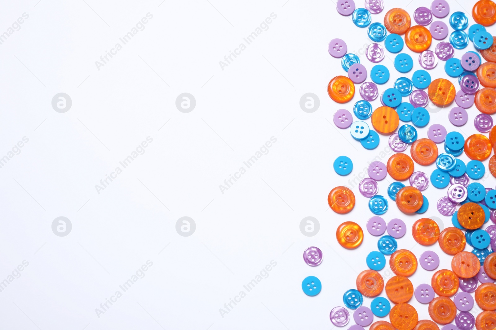 Photo of Many colorful sewing buttons on white background, top view