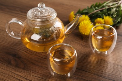 Photo of Delicious fresh dandelion tea on wooden table