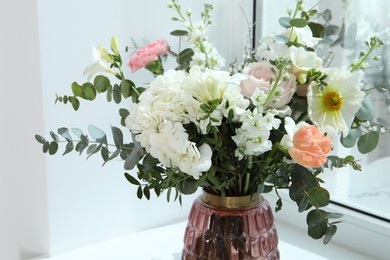 Bouquet of beautiful flowers near window indoors