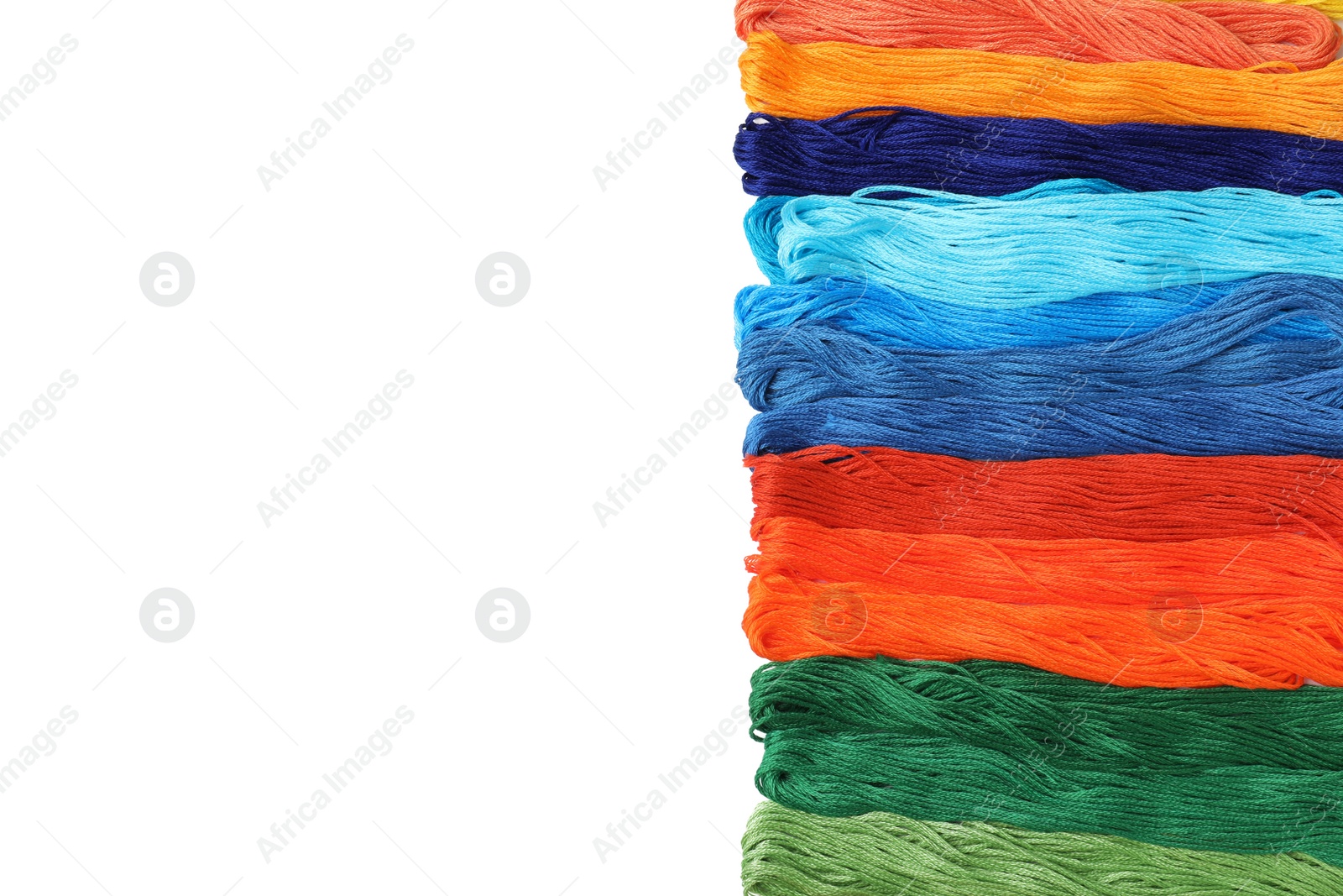 Photo of Set of colorful embroidery threads on white background, top view