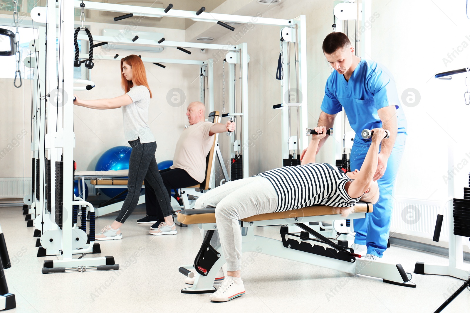 Photo of Patient exercising under physiotherapist supervision in rehabilitation center