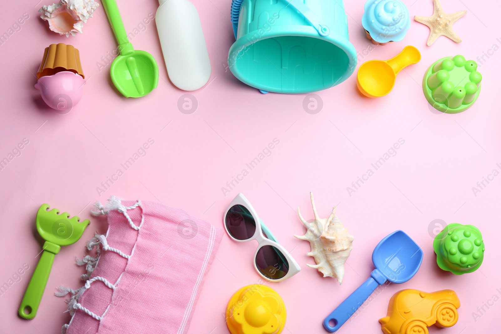 Photo of Flat lay composition with bright beach toys on color background. Space for text