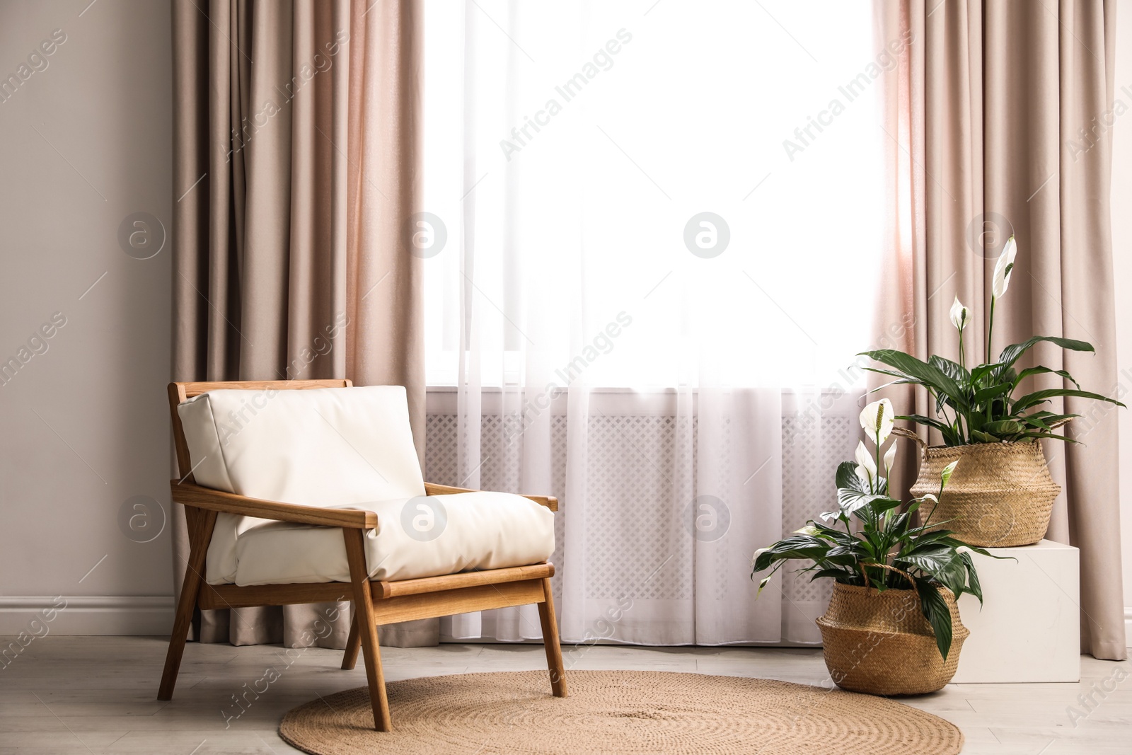 Photo of Comfortable armchair near window with elegant curtains in room