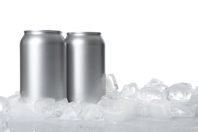 Photo of Tin cans and ice cubes on white background