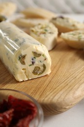 Photo of Tasty butter with olives and green onion on table, closeup