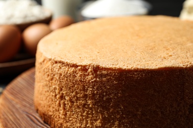 Photo of Delicious fresh homemade cake on wooden board, closeup