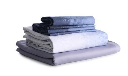 Stack of clean bed linen isolated on white