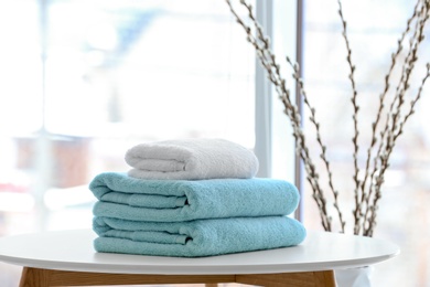 Stack of towels on table against blurred background