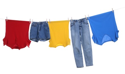 Photo of Different clothes drying on laundry line against white background