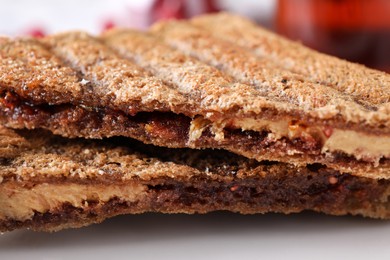 Image of Tasty sandwiches with raspberry jam and peanut butter for breakfast, closeup