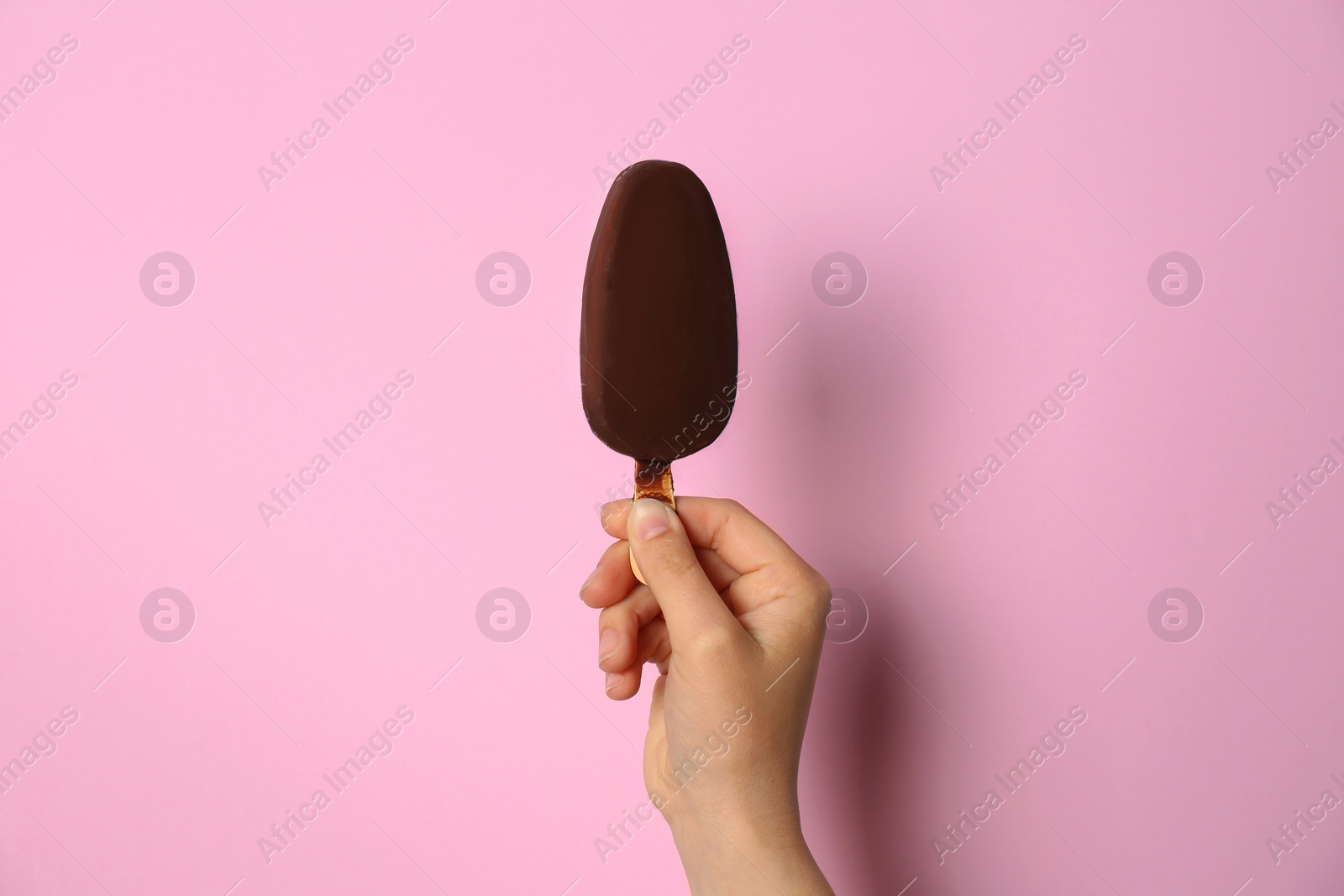 Photo of Woman holding delicious ice cream with chocolate against color background