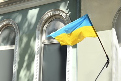 Ukrainian flag on building facade, space for text