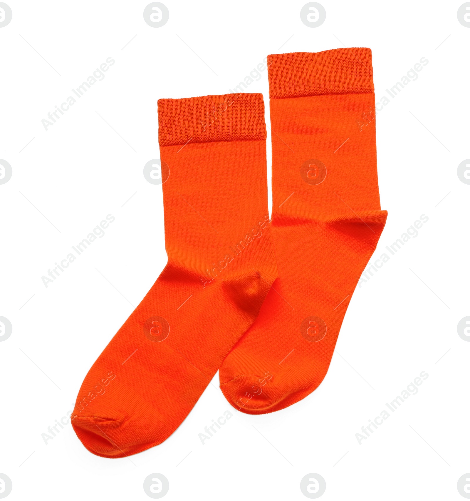 Photo of Orange socks on white background, top view