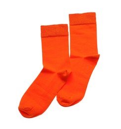 Photo of Orange socks on white background, top view