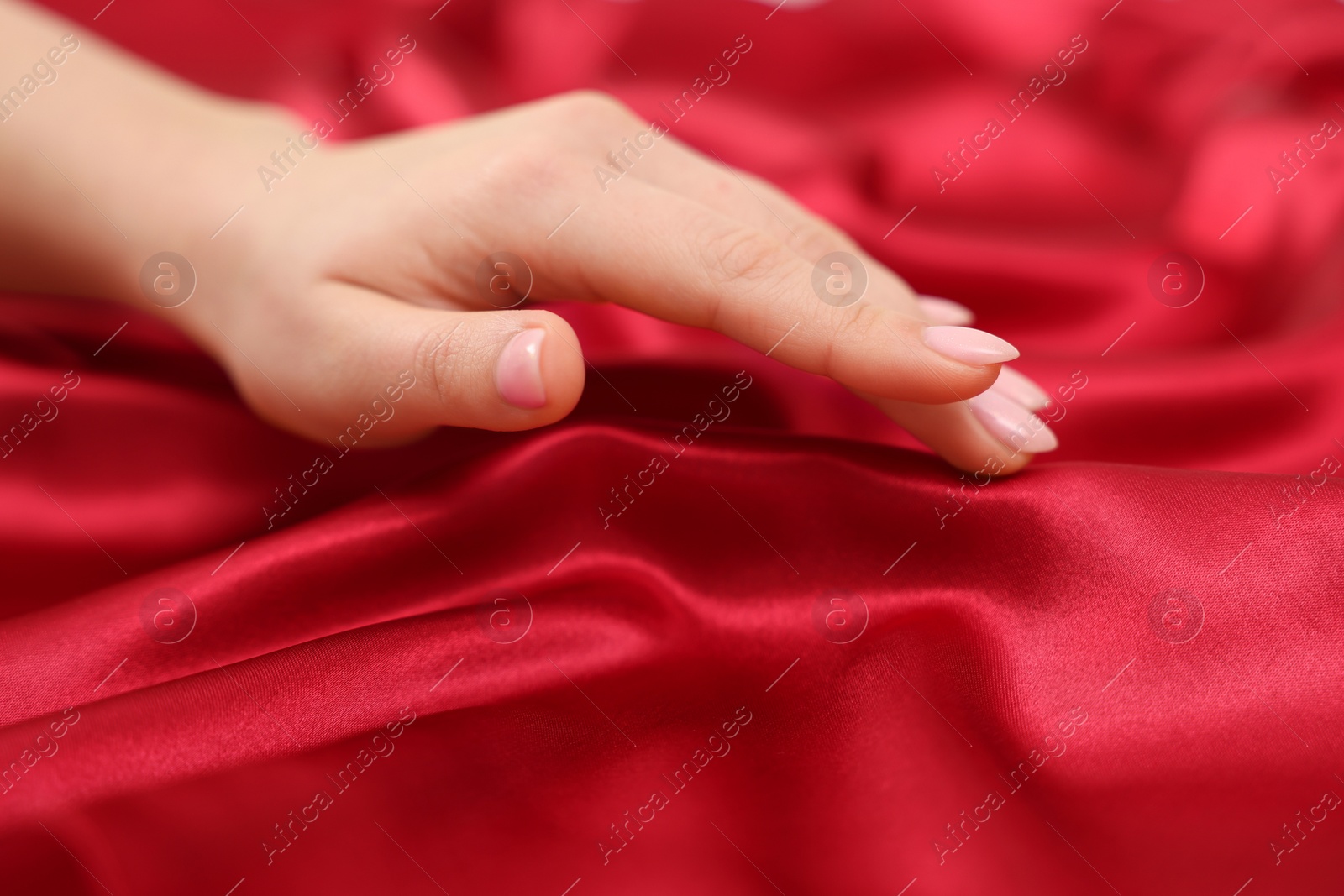 Photo of Woman touching smooth silky fabric, closeup view