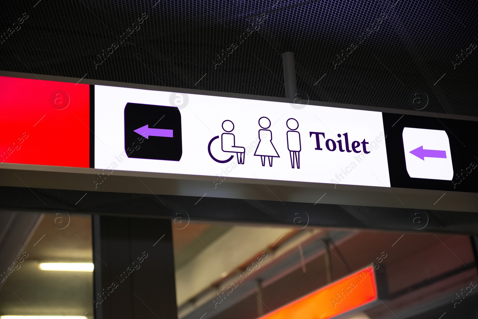 Image of Public toilet sign with symbols and arrow showing direction