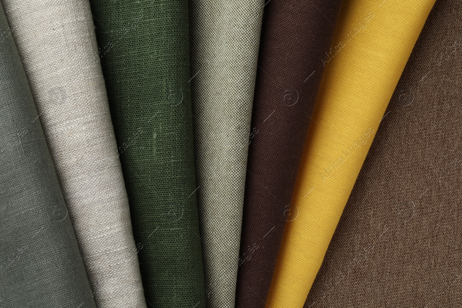 Photo of Many different fabrics on brown cloth, top view