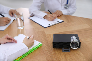 Photo of Video projector on table during medical conference