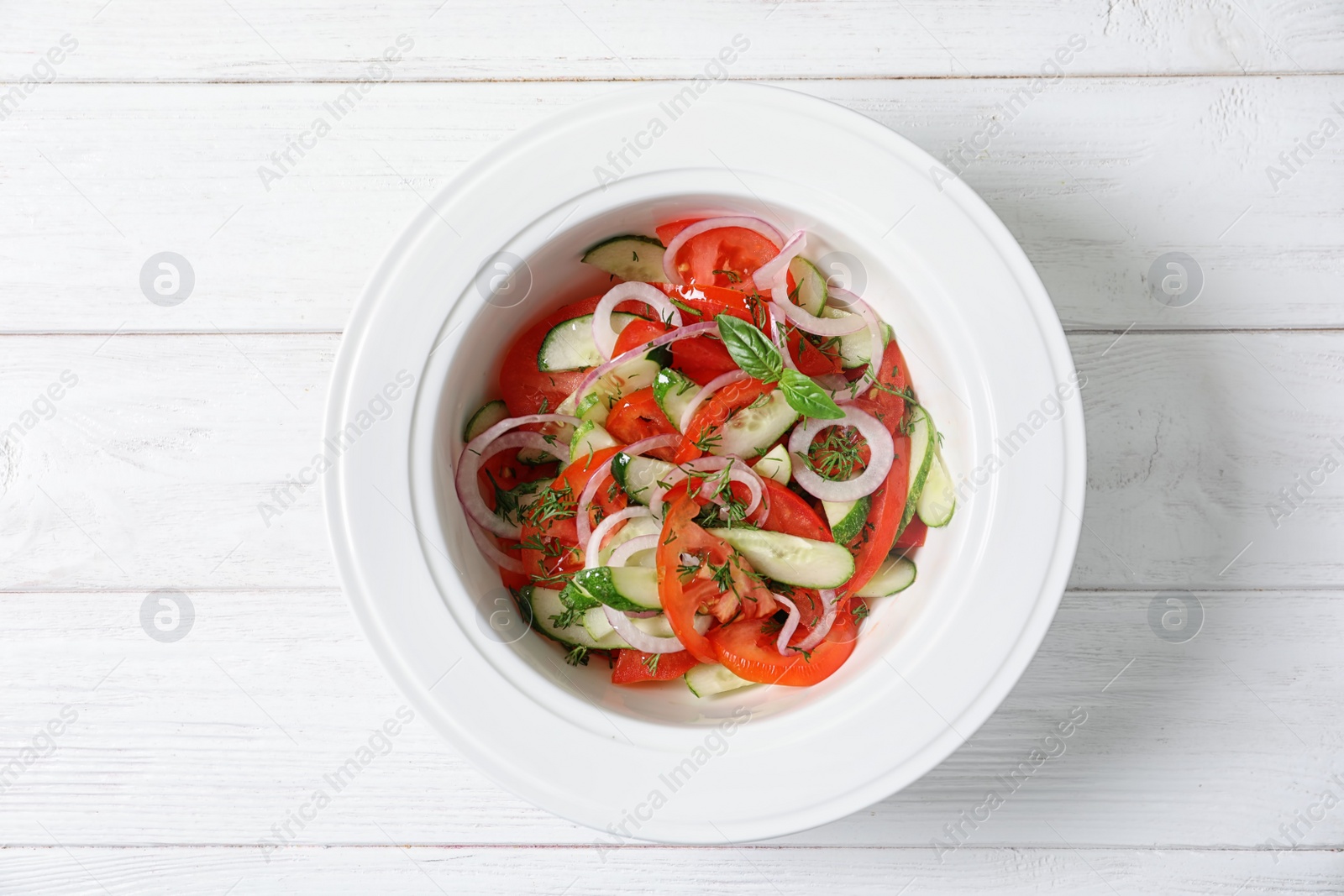 Photo of Plate with delicious fresh salad on table, top view