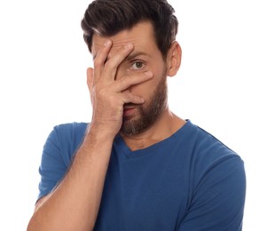 Photo of Embarrassed man covering face with hand on white background