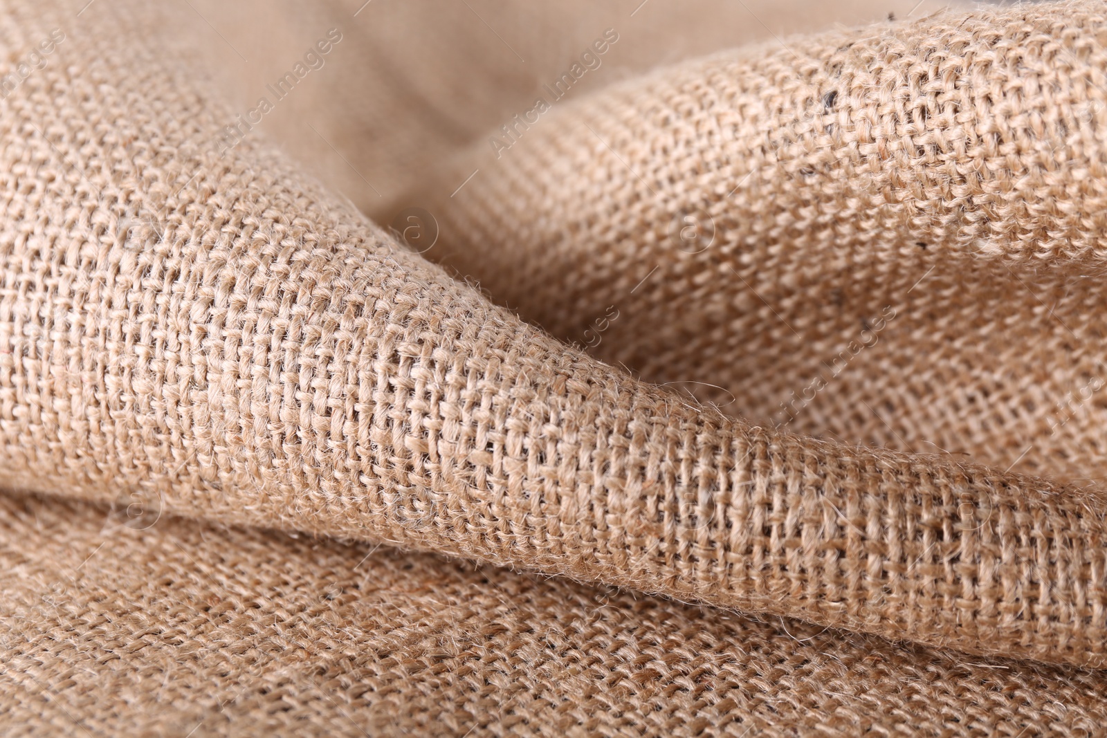 Photo of Texture of beige burlap fabric, closeup view