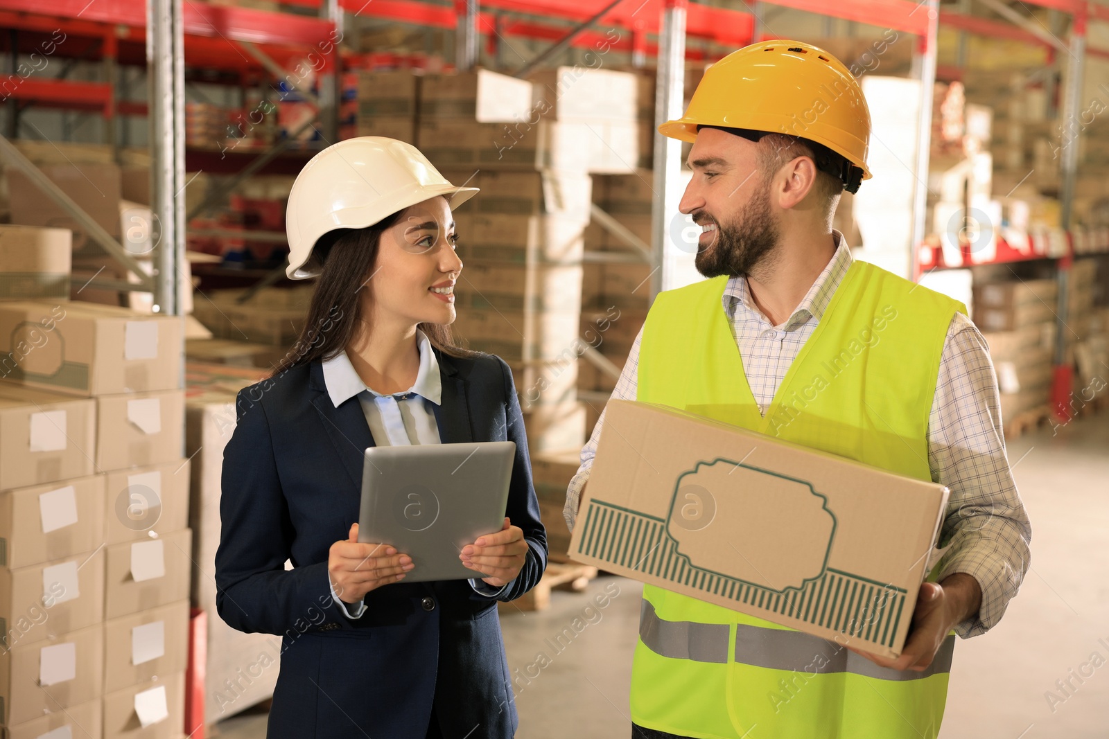 Image of Manager and worker at warehouse. Logistics center