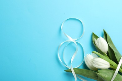 Photo of 8 March card design with tulips and space for text on light blue background, flat lay. International Women's Day