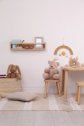 Children's room interior with stylish wooden furniture, toys and decorative elements