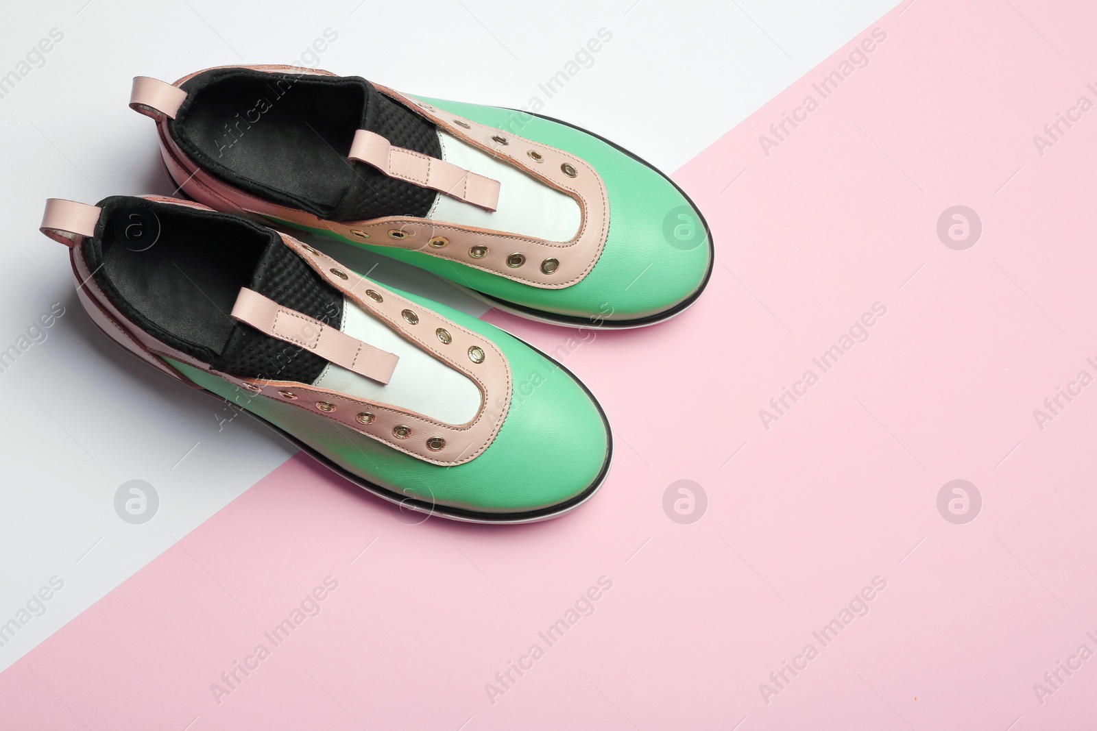 Photo of Flat lay composition of stylish shoes on color background, space for text